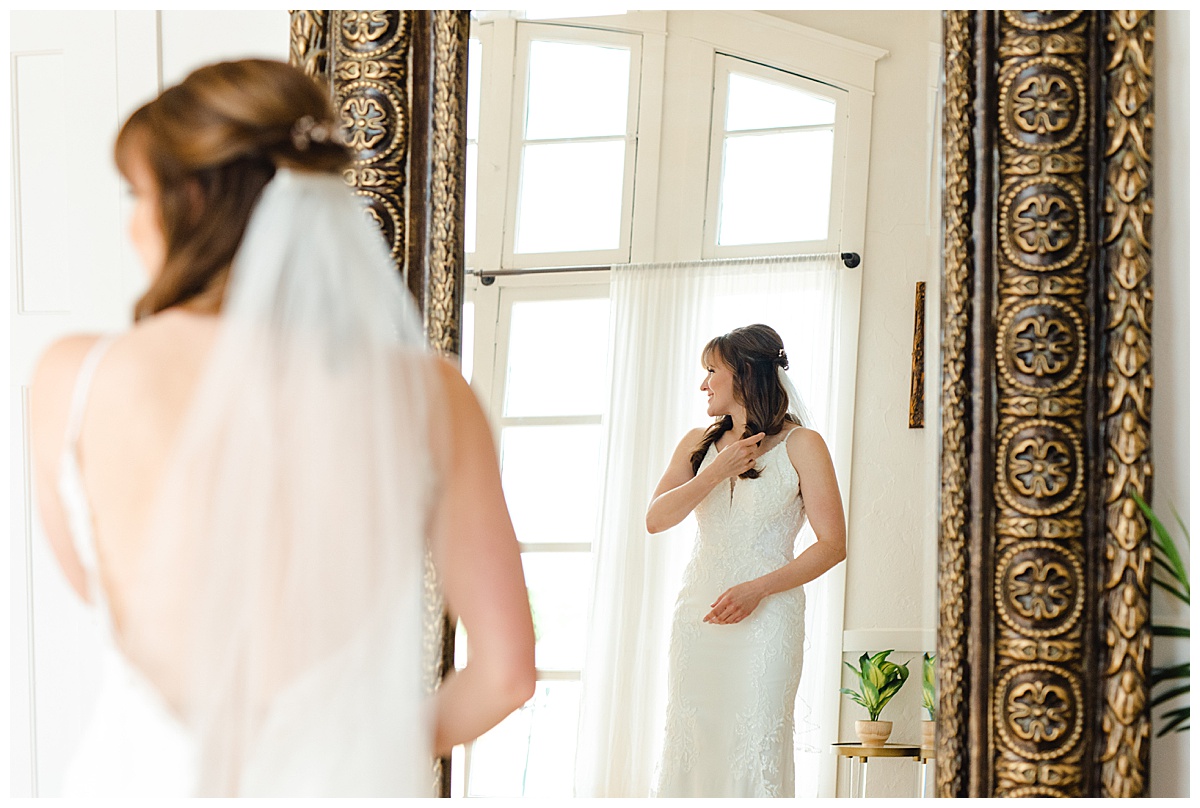 Bride looking in mirror at capitol room