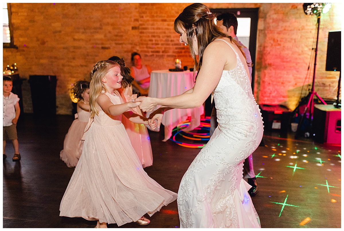 Bride dances with flower girl