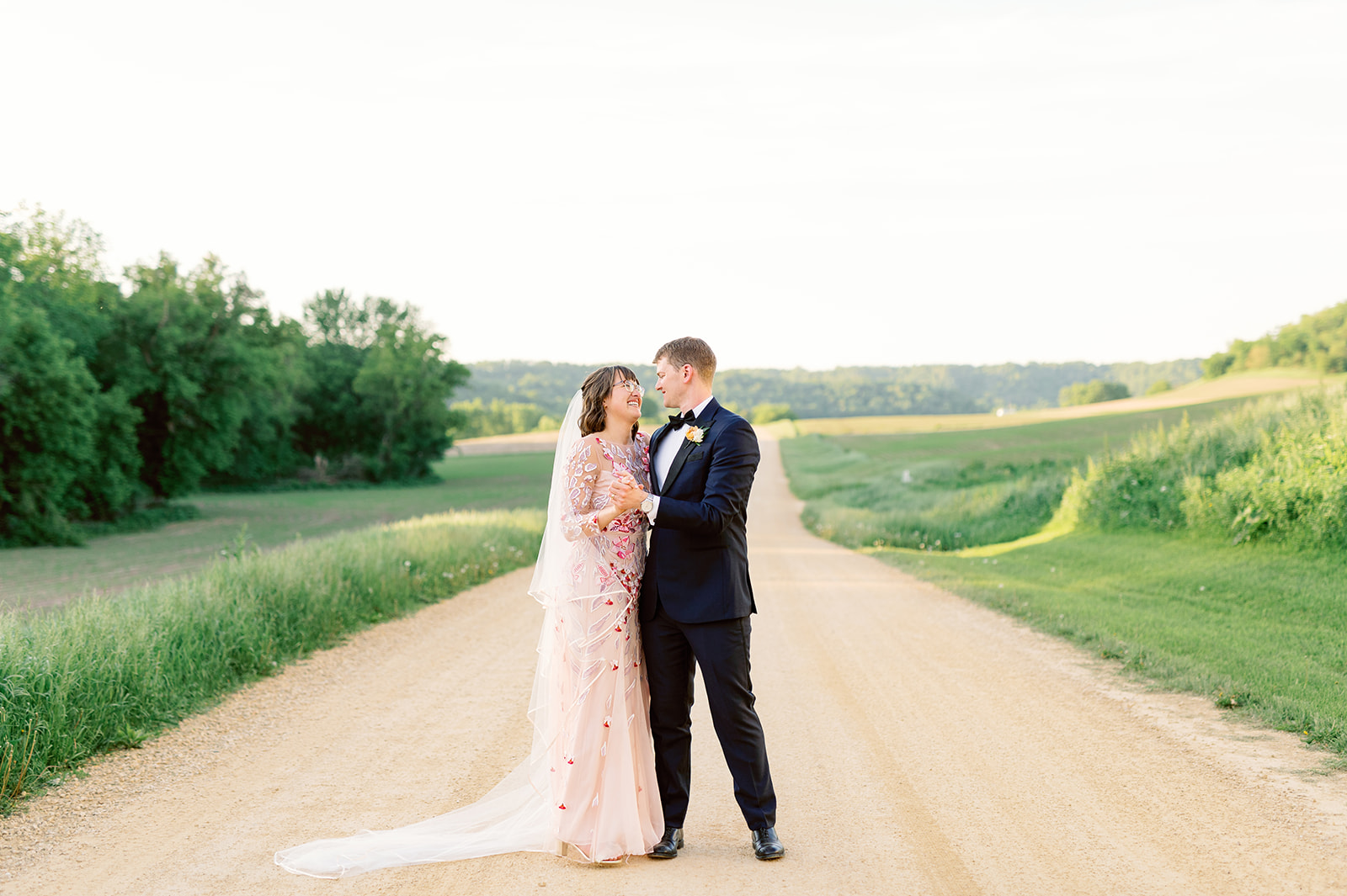 Newlyweds dance in a dirt road on a farm at a Unique Wedding Venues Minnesota