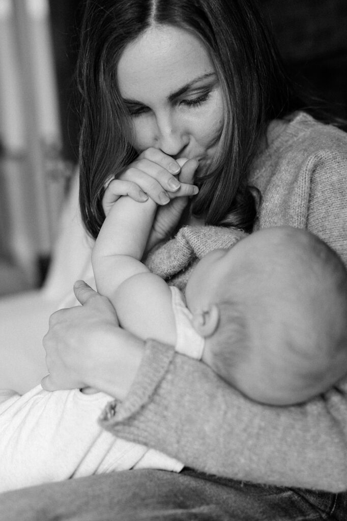 mom kissing baby's hands