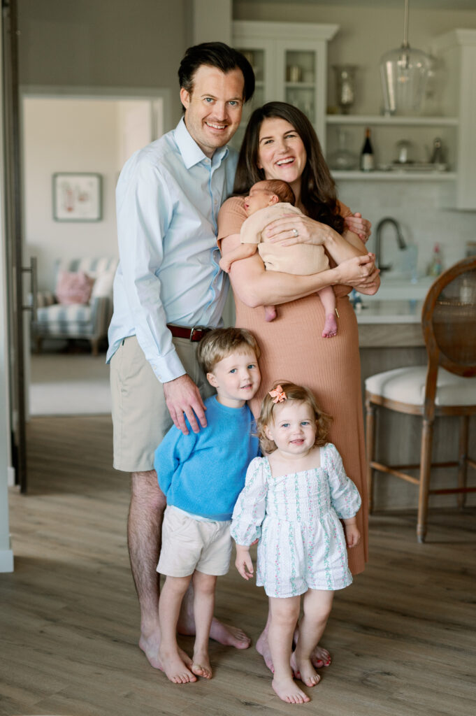 family with newborn baby showing what to wear for newborn photo shoot