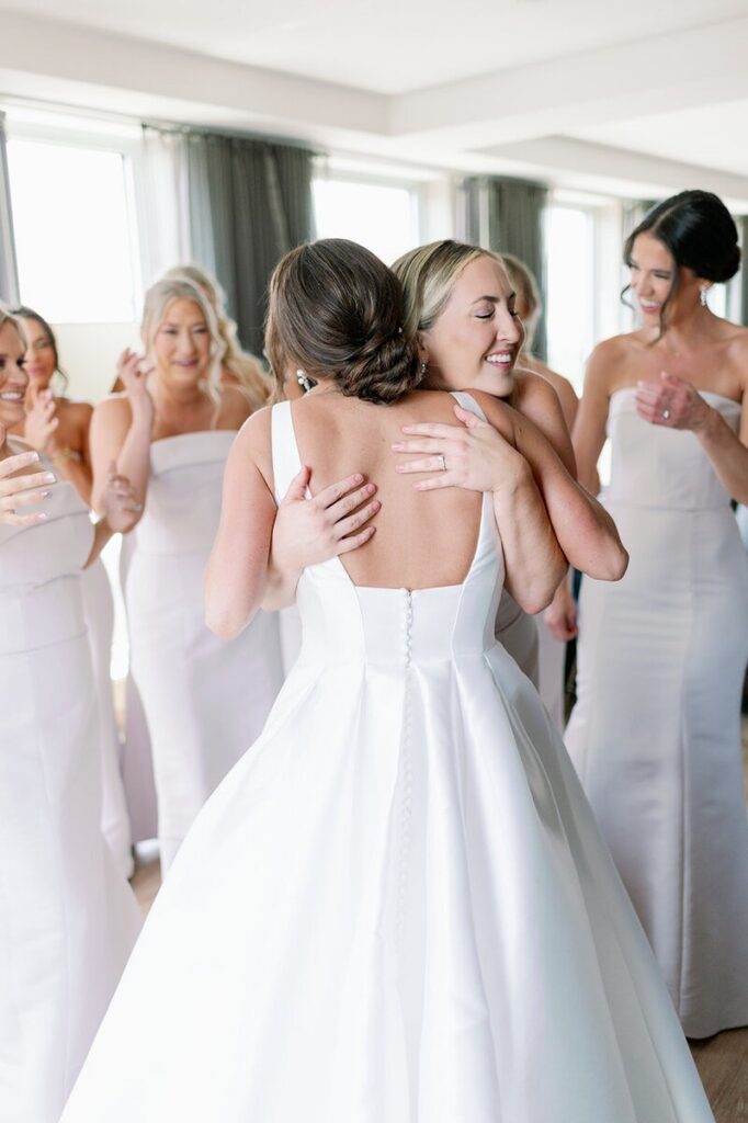 One of the best wedding photographers in MN documenting an emotional hug between the bride and a bridesmaid while getting ready. 