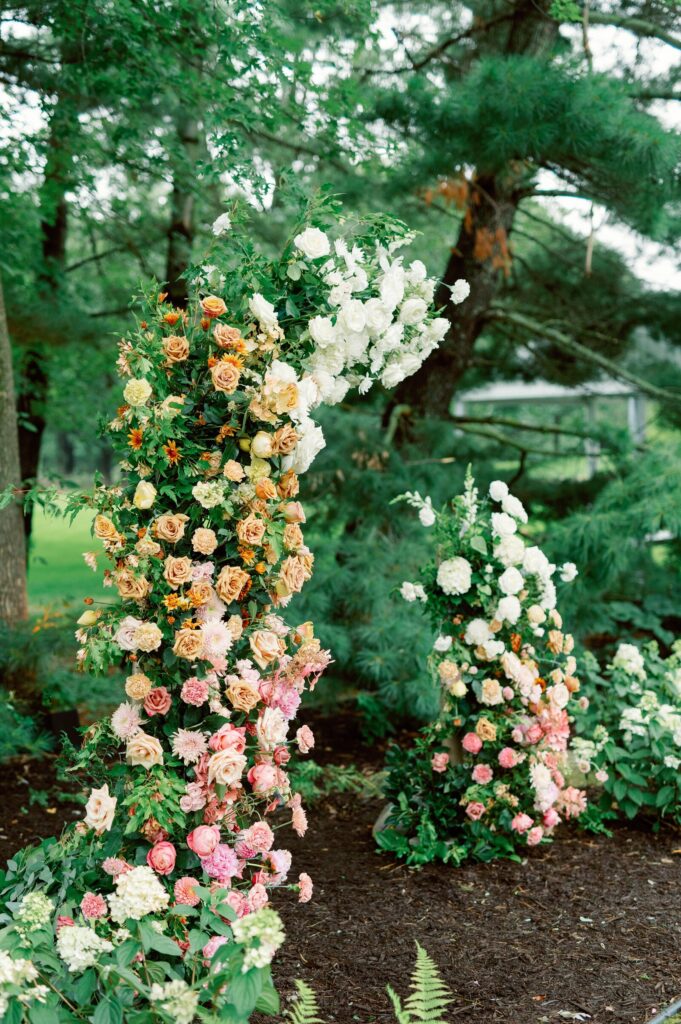 A floral ceremony installations with soft, romantic garden colors, captured by wedding photographers in MN. 