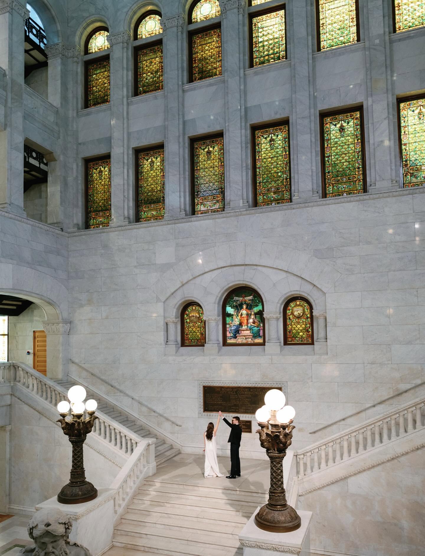 Couple standing on the grand staircase inside Minneapolis City Hall, one of the most unique wedding venues Minneapolis St Paul couples can choose.